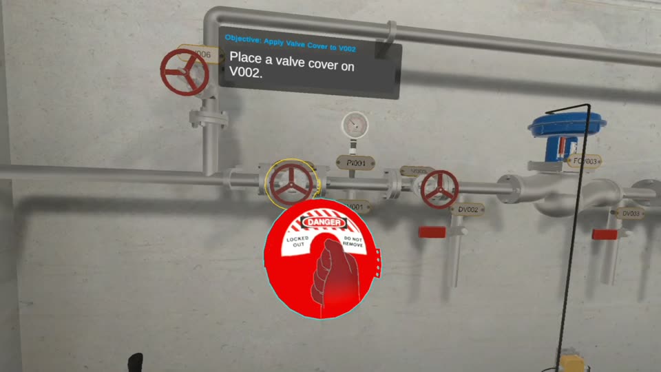 A red valve cover being fitted over a valve handwheel