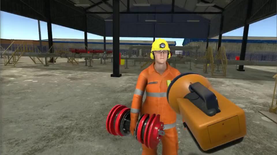 An orange torch on the ground beside a worker holding a pipeline pig