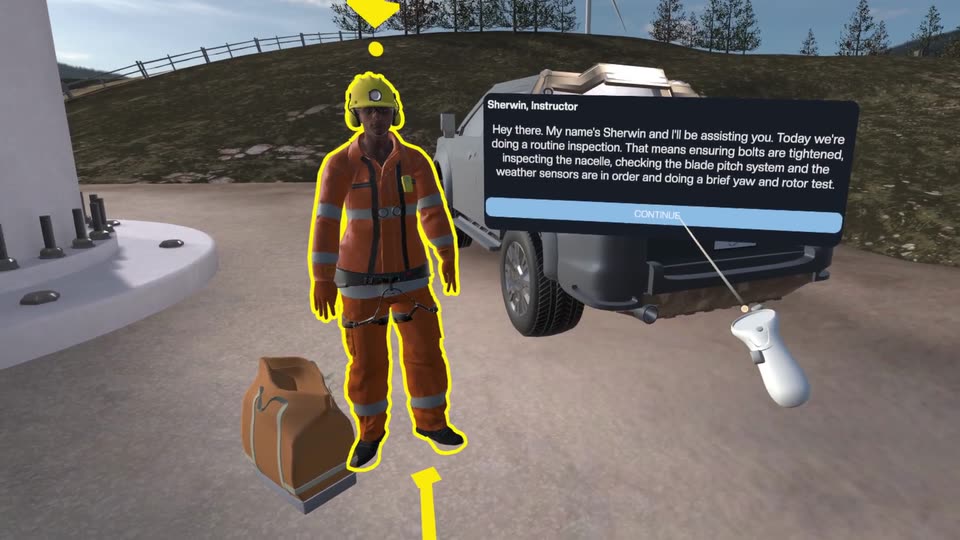 An instructor in orange overalls beside a pickup truck at the foot of a wind turbine